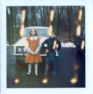 polaroid photo of nine year old standing in red dress